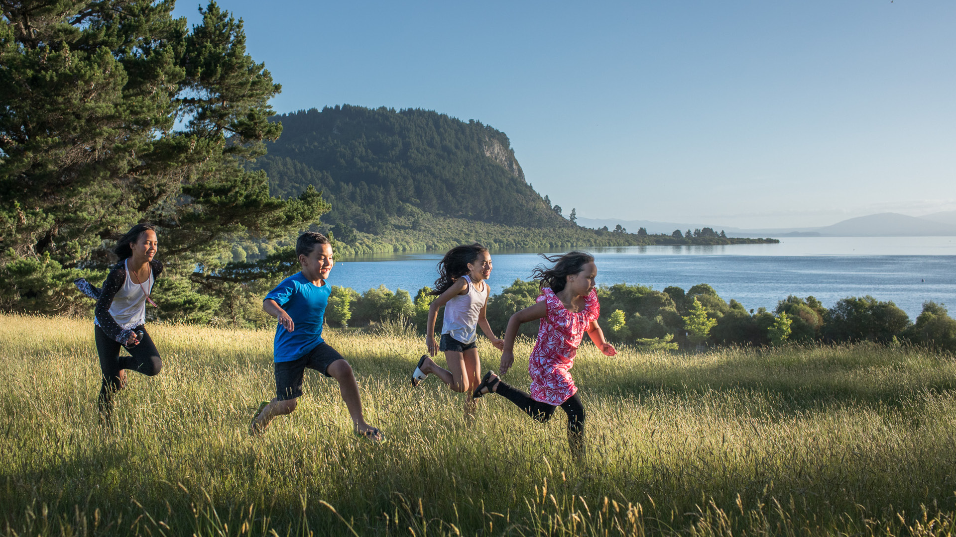 Children running in long grass