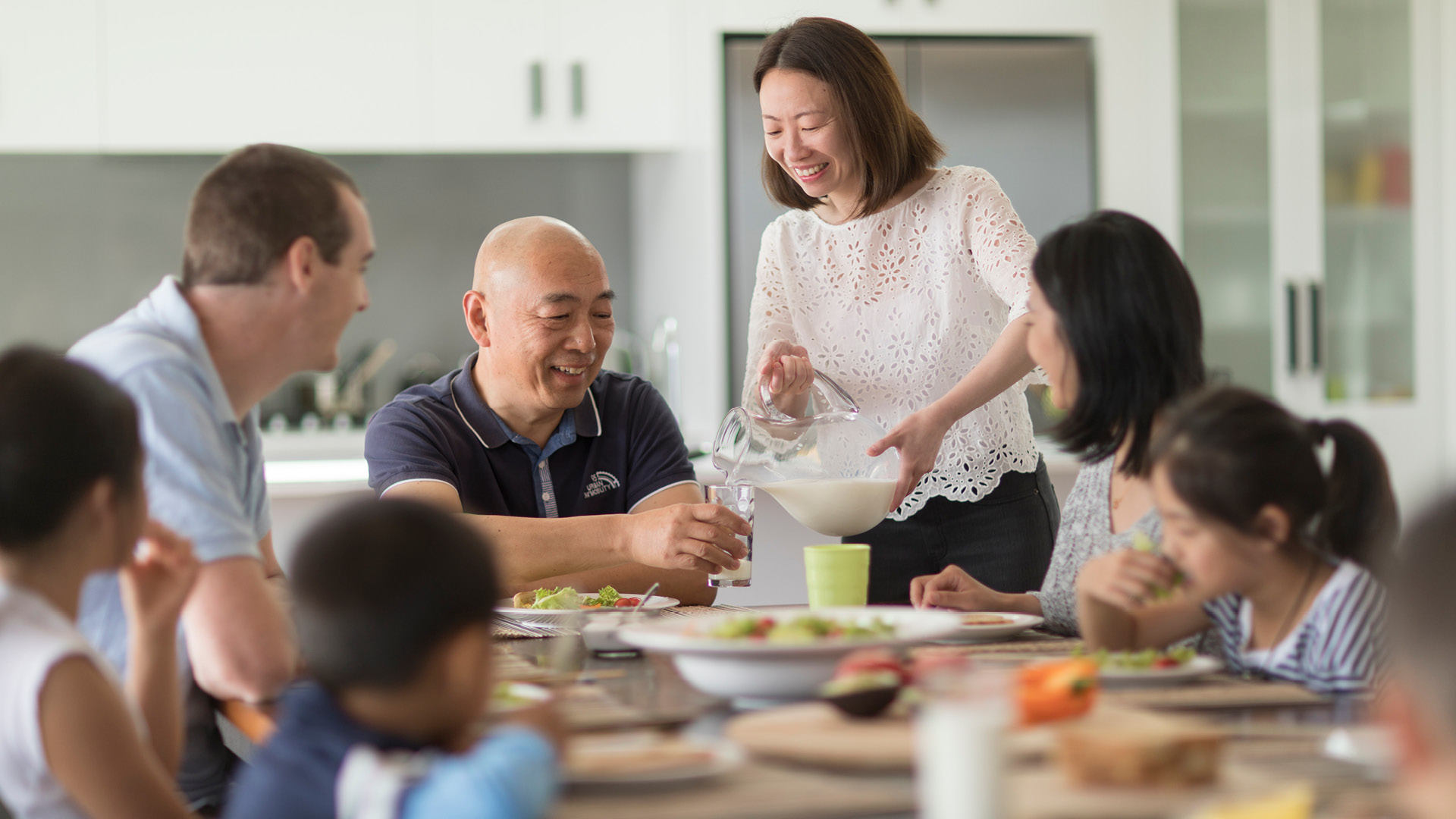 Family enjoying milk at table