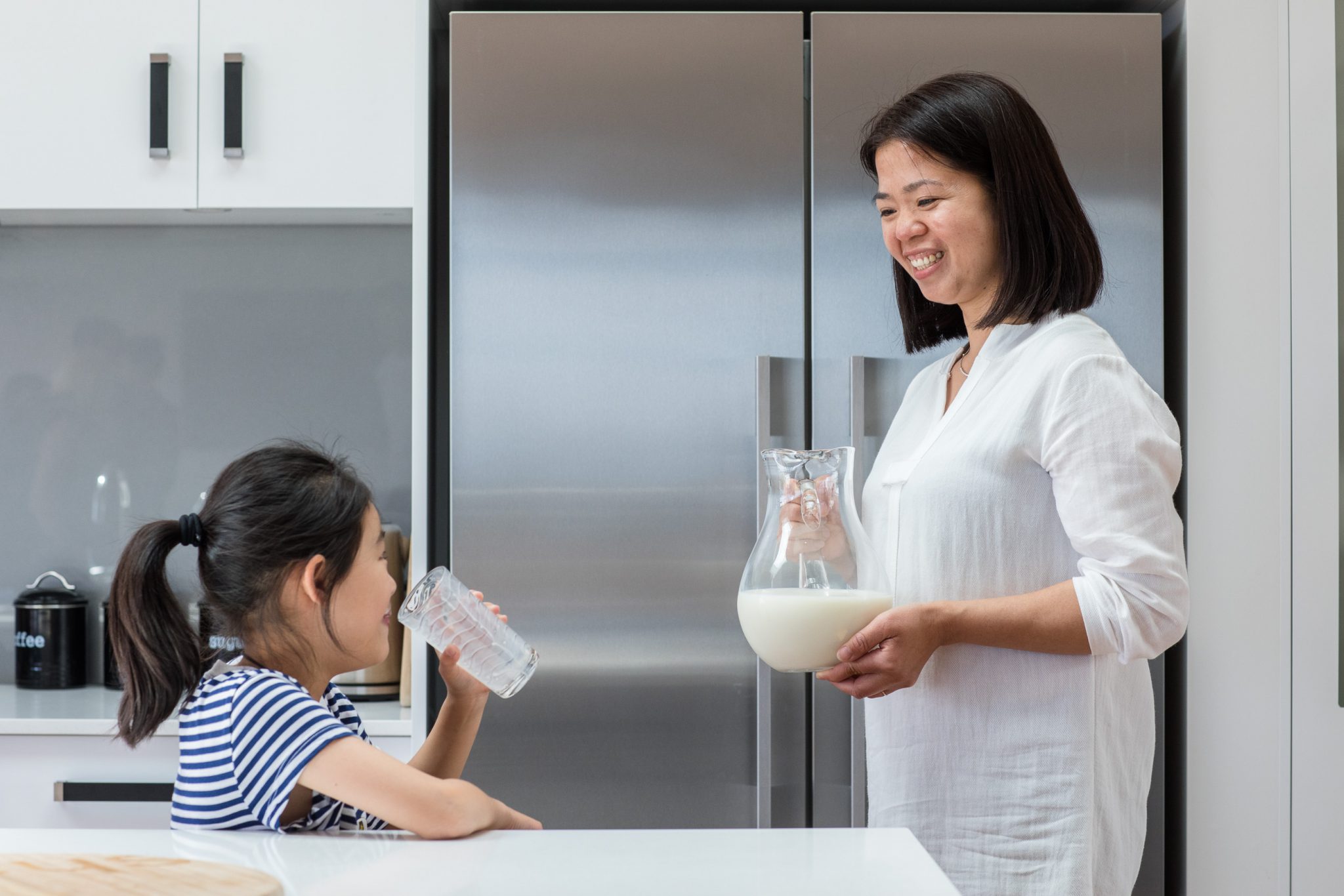 Mother and daughter drinking milk